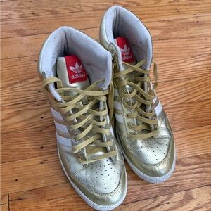 adidas Metallic Gold High-Top Sneakers with White Stripes and Red Tongue